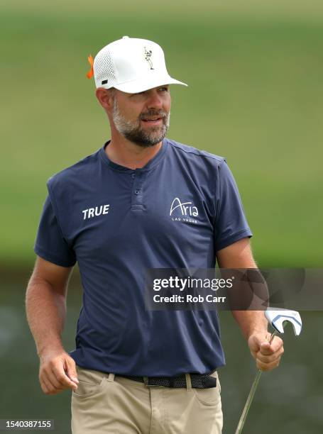 Ryan Moore of the United States reacts to his putt with a ball wave on the 18th hole during the first round of the Barbasol Championship at Keene...