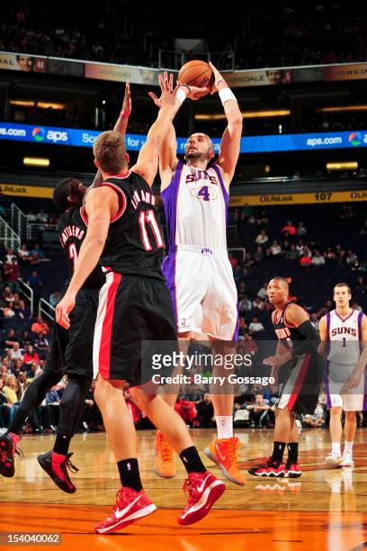 Marcin Gortat of the Phoenix Suns shoots against Meyers Leonard and Wesley Matthews of the Portland Trail Blazers during a pre-season game on October...