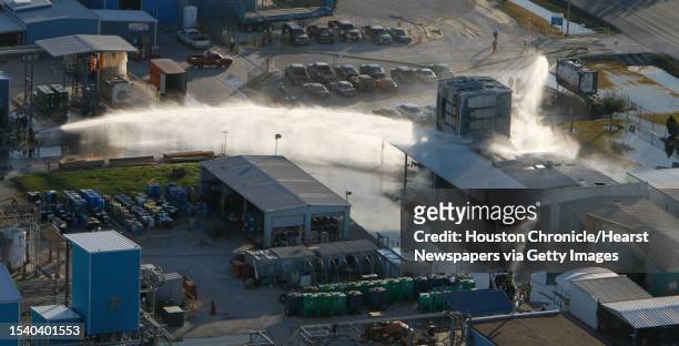 Firefighters spray water on the Azko Nobel Chemical building after several explosions were reported, injuring one person Tuesday in Deer Park. **No...