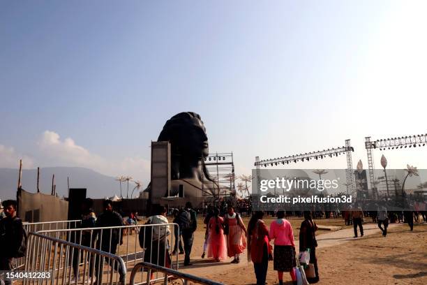 group of people gather together during mahashivratri festival celebration event in front of aadiyogi lord shiva 112 feet tall statue. - coimbatore stock pictures, royalty-free photos & images