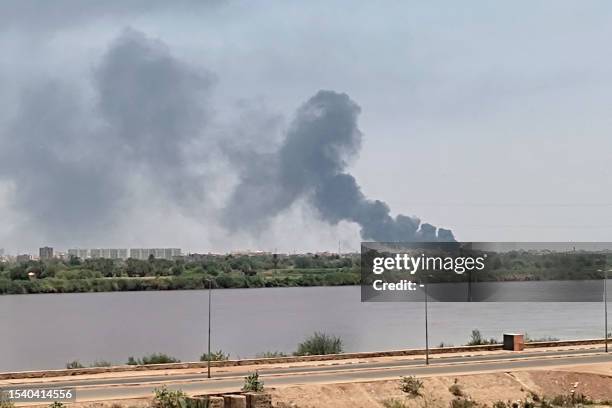 Picture taken from Omdurman shows smoke billowing in the distance in Khartoum North amid ongoing fighting in war-torn Sudan, on July 18, 2023....