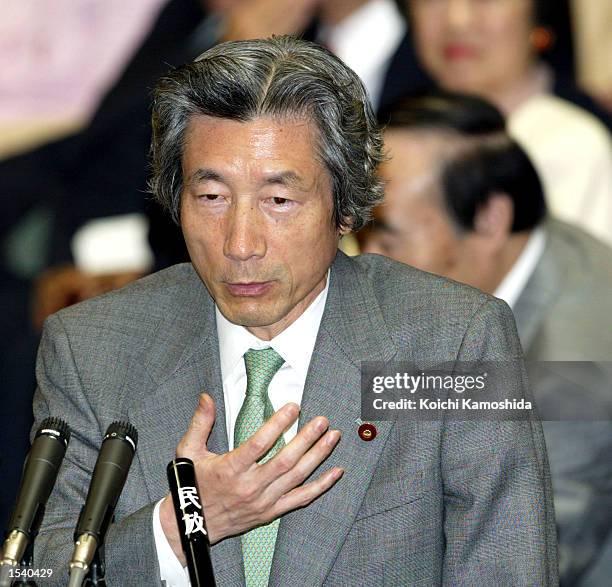 Japanese Prime Minister Junichiro Koizumi answers questions as a House of Representatives special committee begins discussing three bills governing...