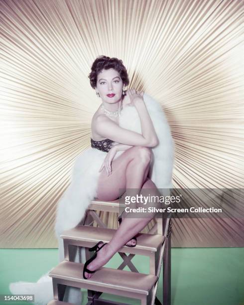 American actress Ava Gardner wrapped in a white fur stole, 1953.