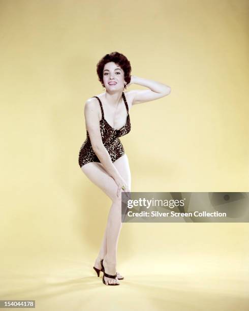 Argentine-American actress Linda Cristal in a leopard-print one-piece swimsuit, circa 1958.