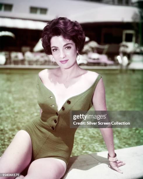 Argentine-American actress Linda Cristal in a green one-piece swimsuit, circa 1958.