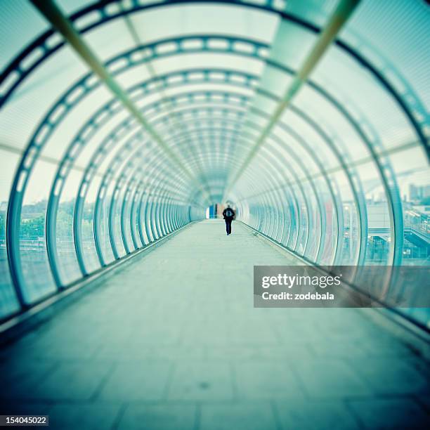 man walking inside futuristic tunnel, tilt shift - tilt shift stock pictures, royalty-free photos & images