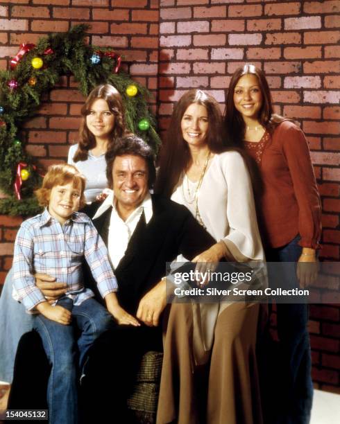 American country singer-songwriter Johnny Cash with his wife June Carter Cash and three of their children, circa 1976. Left to right; John Carter...