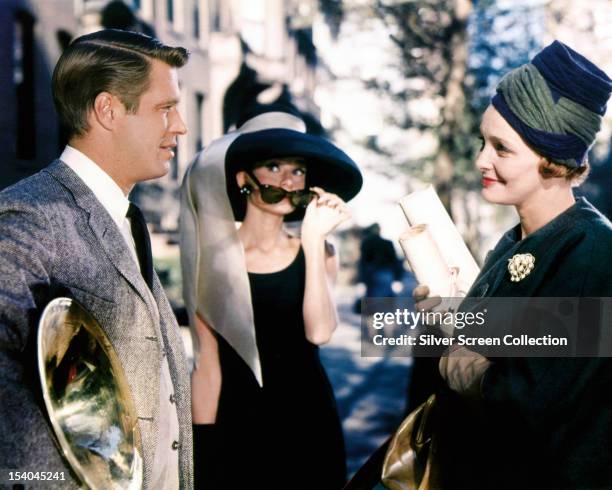 From left to right, American actor George Peppard as Paul Varjak, Belgian-born actress Audrey Hepburn as Holly Golightly, and American actress...