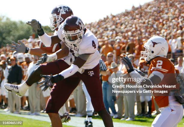 Melvin Bulitt, back intercepts a ball as he and Danny Gorrer , defend Billy of Pittman of Texas in the second quarter of his game Saturday, Nov. 24...