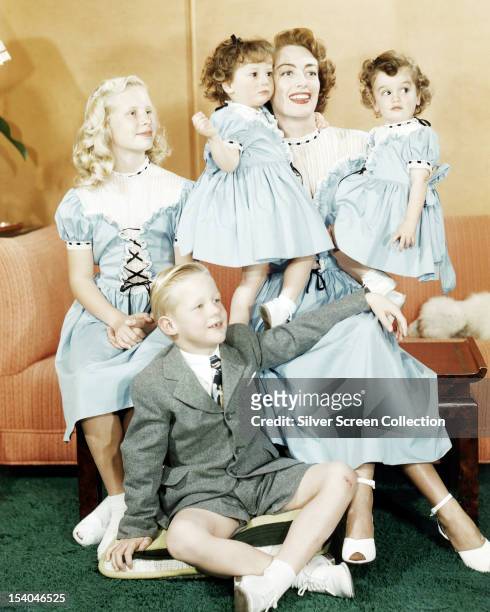 American actress Joan Crawford with her daughter Christina , her son Christopher and her adopted, identical twin daughters, Cindy and Cathy, circa...