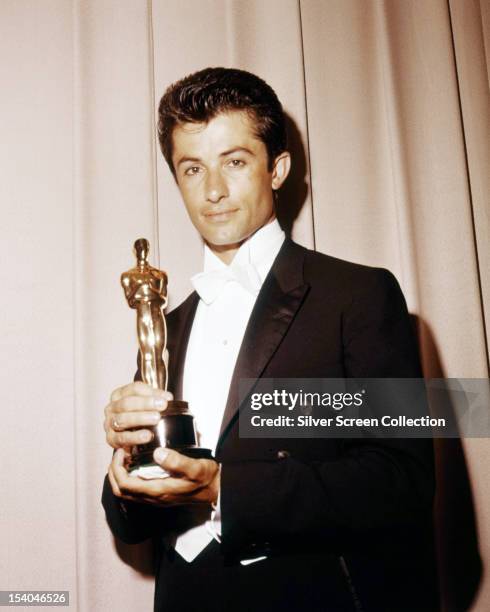 Greek-American dancer and actor George Chakiris with his oscar for Best Supporting Actor, for 'Westside Story', at the 34th Academy Awards, held at...