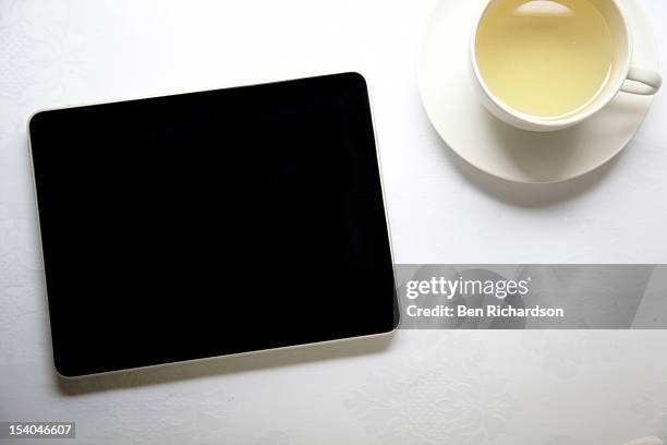 computer tablet on table top - tablet on table from top stock pictures, royalty-free photos & images