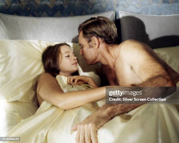 American actor Charlton Heston as Thorn, and Leigh Taylor-Young as Shirl in a love scene from 'Soylent Green', directed by Richard Fleischer, 1973.