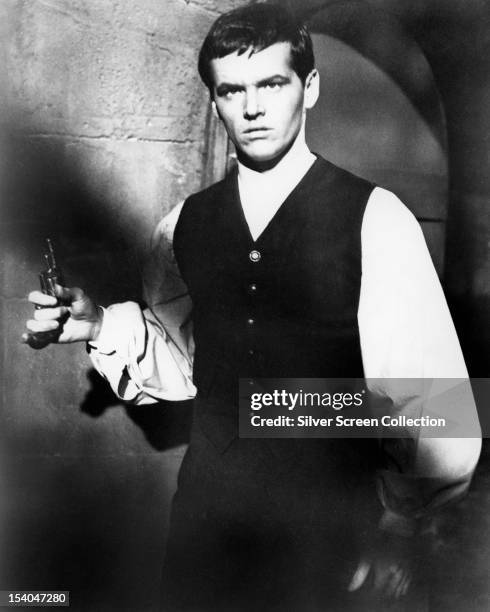 American actor Jack Nicholson holding a pistol, as Andre Duvalier in 'The Terror', directed by Roger Corman, 1963.