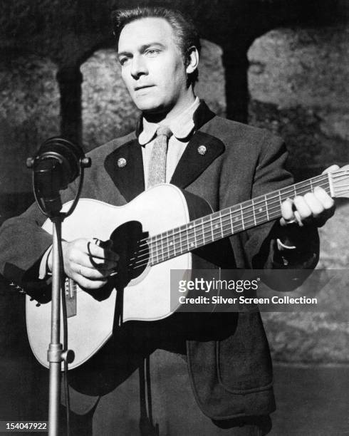Canadian actor Christopher Plummer, as Captain Georg von Trapp, playing a guitar in 'The Sound of Music', directed by Robert Wise, 1965.