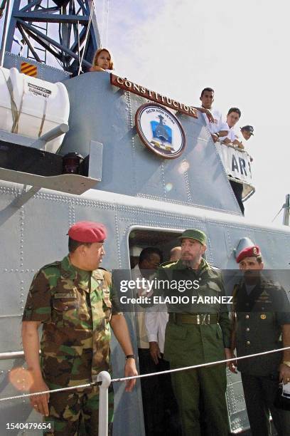 Venezuelan President Hugo Chavez and his Cuban counterpart Fidel Castro are seen aboard a military vessel in Pampatar, Venezuela 11 December 2001....