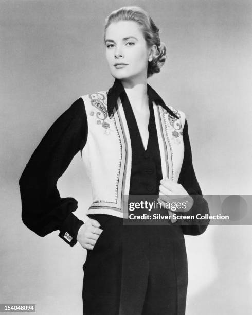 American actress Grace Kelly wearing an embroidered waistcoat, circa 1955.