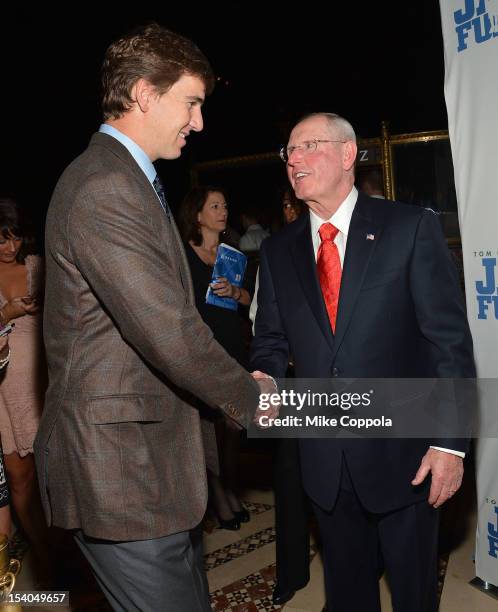 New York football Giants quarterback Eli Manning and New York football Giants head coach Tom Coughlin shake hands at the Tom Coughlin 8th Annual...