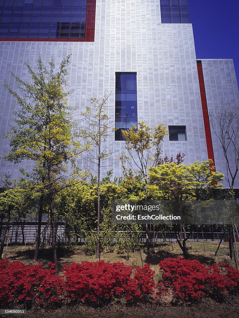 Futuristic office facade and colorful planting