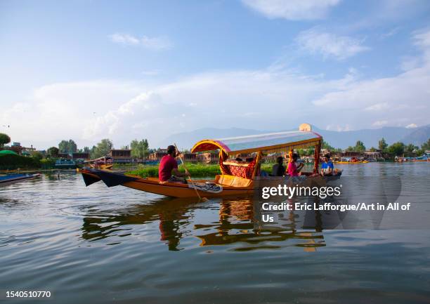 Shikara boat with tourists on Dal lake, Jammu and Kashmir, Srinagar, India on June 12, 2023 in Srinagar, India.