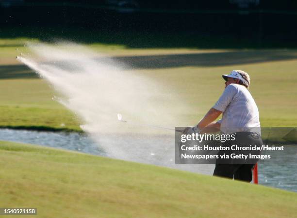 Andy bean kicks up a bunch of sand as he chips out of the sand trap at the 18th hole during the Administaff Small Business Classic Saturday, Oct. 13,...