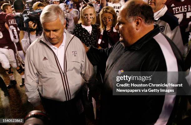 Texas A&M coach Dennis Franchione Left, walks away atfter congratulating Kansas coach Mike Mangino Saturday, Oct. 27 at Kyle Field on the Texas A&M...