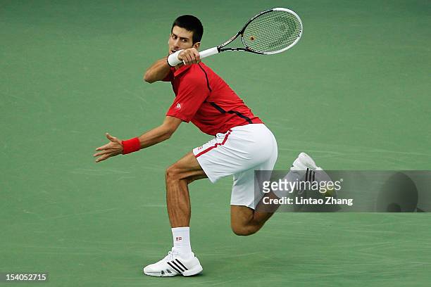 Novak Djokovic of Serbia returns a shot to Tomas Berdych of Czech Republic during the Men's Single Semifinal of the Shanghai Rolex Masters at the Qi...