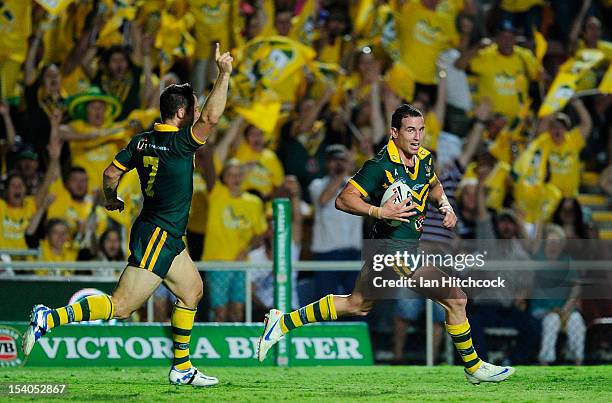 Darius Boyd of the Kangaroos races away to score a try while Cooper Cronk celebrates during the International Test match between the Australian...