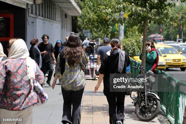 Women walk on the streets during daily life as the country's morality police resume hijab patrols in Tehran, Iran on July 18, 2023. ''Prosecutors in...