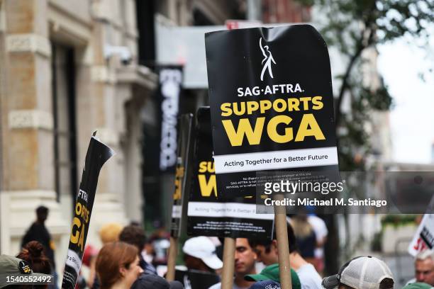 Members of the Writers Guild of America East are joined by SAG-AFTRA members as they picket on Day 1 at the Warner Bros. Discovery NYC office on July...
