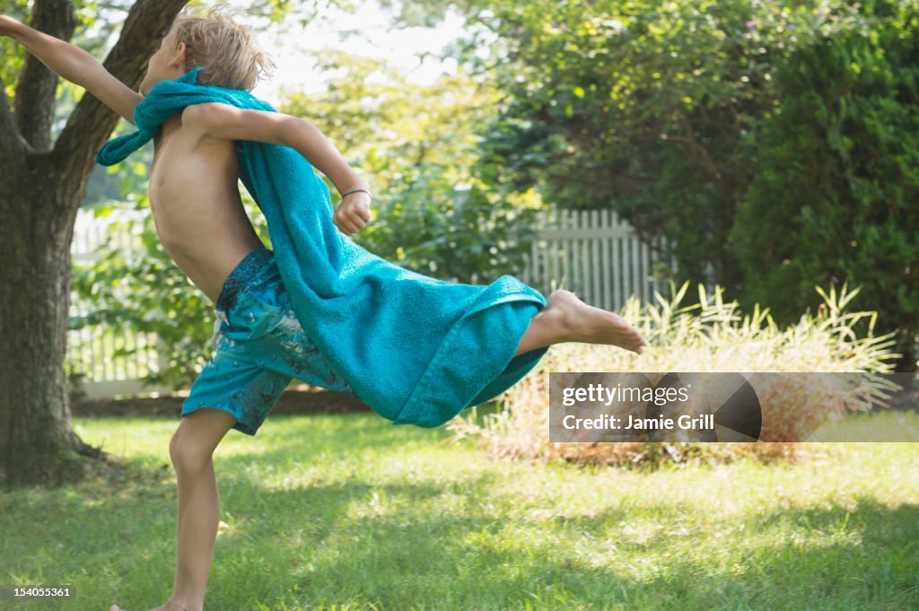 Young boy pretending to be a super hero