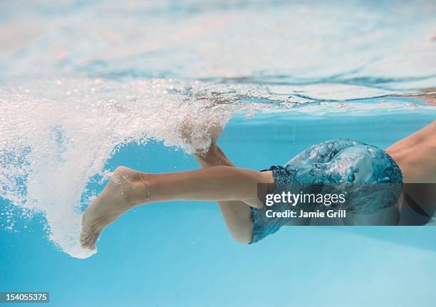 young boy kicking underwater - swimming lessons stock pictures, royalty-free photos & images