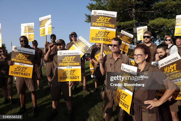 Workers and Teamsters members practice picket outside a UPS distribution facility in Madison Heights, Michigan, US, on Tuesday, July 18, 2023. United...