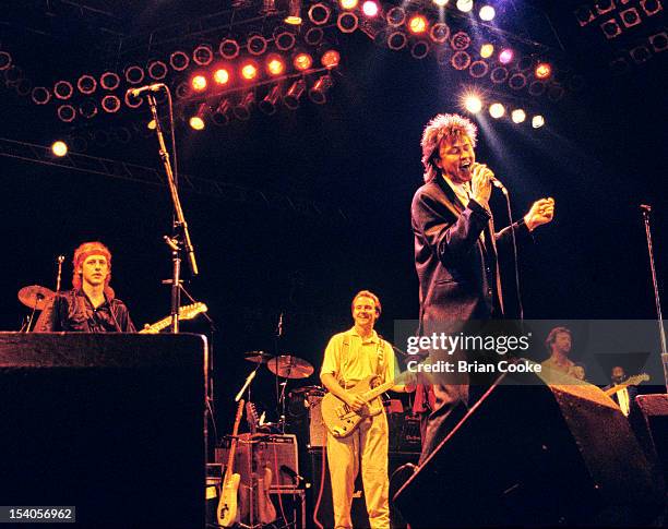 Paul Young performing on stage at The Prince's Trust 10th Birthday Party at Wembley Arena, London, United Kingdom on 20th June 1986. Behind him from...