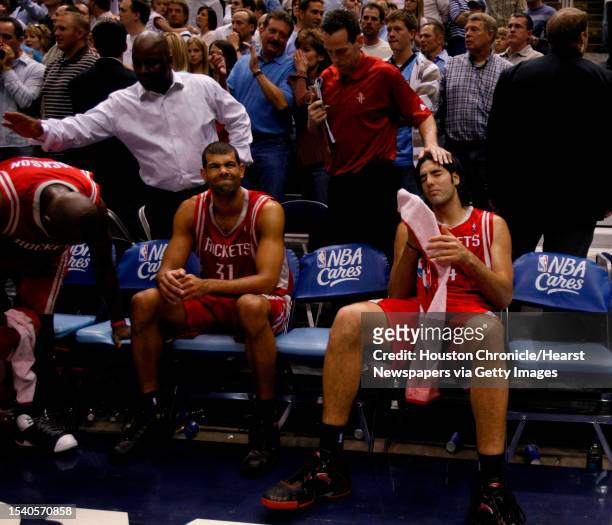 Houston Rockets assistants comfort Houston Rockets guard Bobby Jackson, left, Houston Rockets forward Shane Battier, center and Houston Rockets...