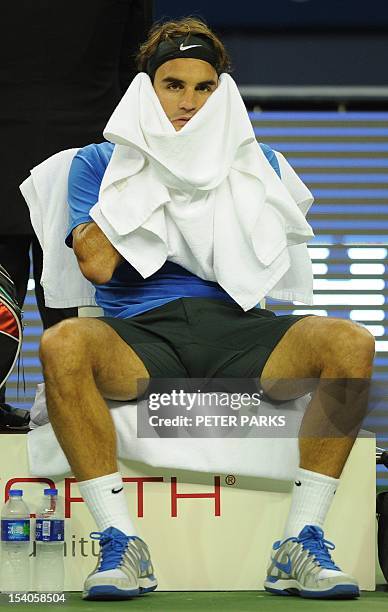 Roger Federer of Switzerland wipes his face during a break against Andy Murray of Britain in their semi-final match of the Shanghai Masters tennis...