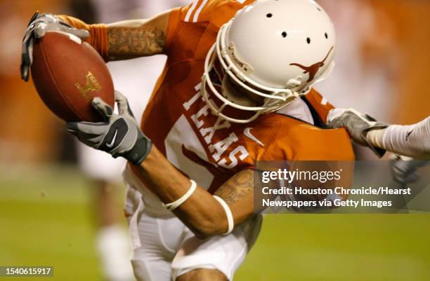 Texas wide receiver Brandon Collins , front, fights his way past Texas A&M defensive back Danny Gorrer for a touchdown in the second quarter of his...