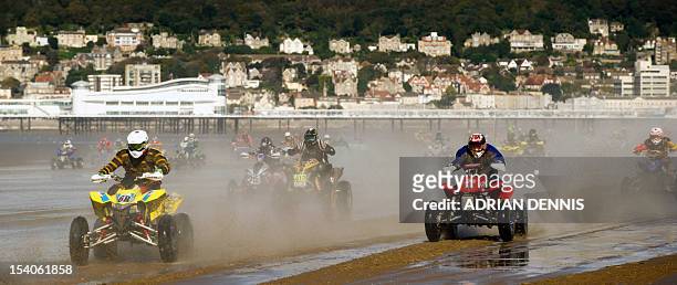 Quadbike riders race down the beach during the main quad and sidecar race during the 2012 RHL Weston beach race in Weston-Super-Mare, southwest...