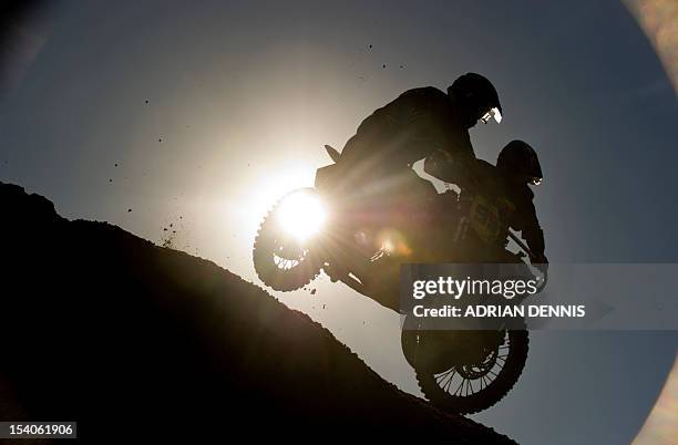 Daniel and Joe Millard jump over the crest of a dune on their Husaberg 650 sidecar during the main quad and sidecar race during the 2012 RHL Weston...