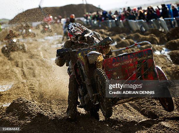 Alun Davies rides his sidecar along a straight during the main quad and sidecar race during the 2012 RHL Weston beach race in Weston-Super-Mare,...