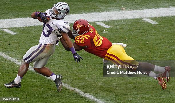Running back John Hubert of the Kansas State Wildcats is brought down during the second quarter by linebacker Jeremiah George of the Iowa State...