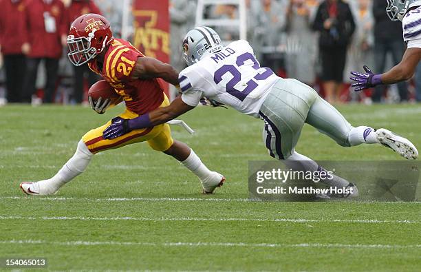 Running back Shontrelle Johnson of the Iowa State Cyclones rushes up field during the first quarter past defensive back Jarard Milo of the Kansas...
