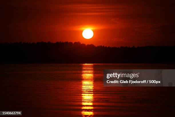 scenic view of sea against orange sky,baltezers,latvia - latvia sea stock pictures, royalty-free photos & images