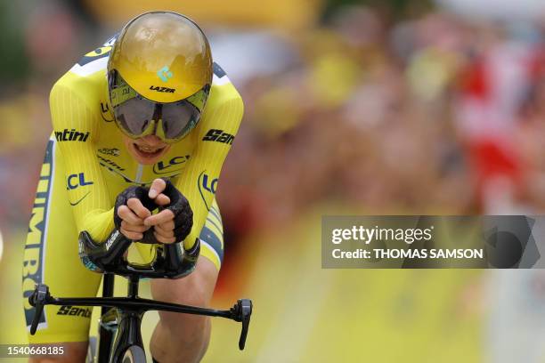 Jumbo-Visma's Danish rider Jonas Vingegaard wearing the overall leader's yellow jersey cycles to the finish line during the 16th stage of the 110th...