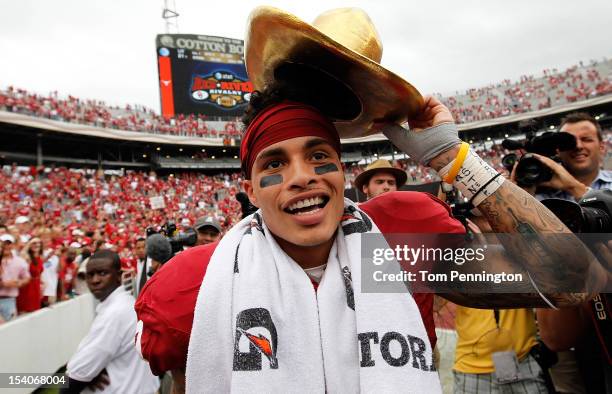 Kenny Stills of the Oklahoma Sooners celebrates with the AT&T Red River Rivalry trophy after the Oklahoma Sooners beat the Texas Longhorns 63-21 at...