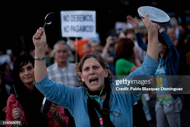 People bang pots and shout slogans during the Global Noise demonstration in Paseo de la Castellana on October 13, 2012 in Madrid, Spain. Global Noise...