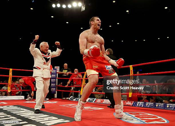 David Price celebrates victory over Audley Harrison during their British and Commonwealth Heavyweight Championship fight also in the ring celebrating...