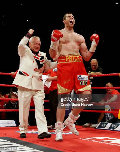 David Price celebrates victory over Audley Harrison during their British and Commonwealth Heavyweight Championship fight also in the ring celebrating...