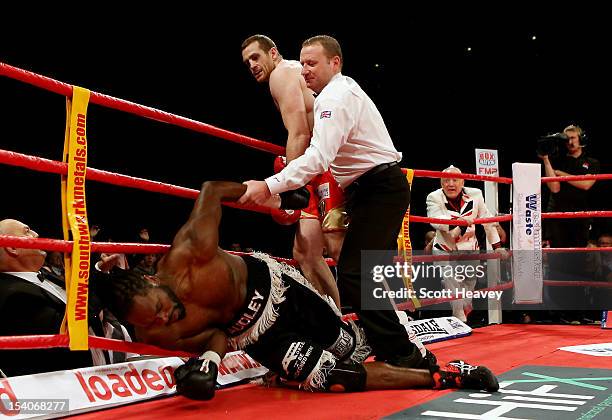 David Price knocks down Audley Harrison during their British and Commonwealth Heavyweight Championship fight on October 13, 2012 in Liverpool,...