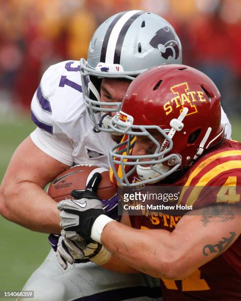 Fullback Braden Wilson of the Kansas State Wildcats makes helmet to hemet contact during the fourth quarter with linebacker A.J. Klein of the Iowa...